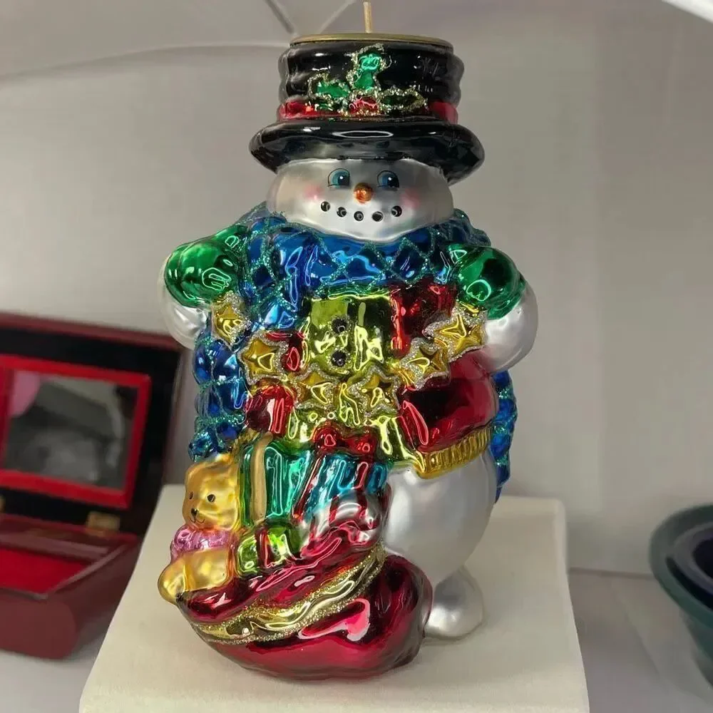 Charming hand-blown mercury glass snowman candle holder.